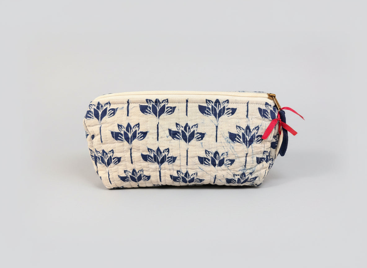 Fabric pouch with blue floral pattern on a dark background