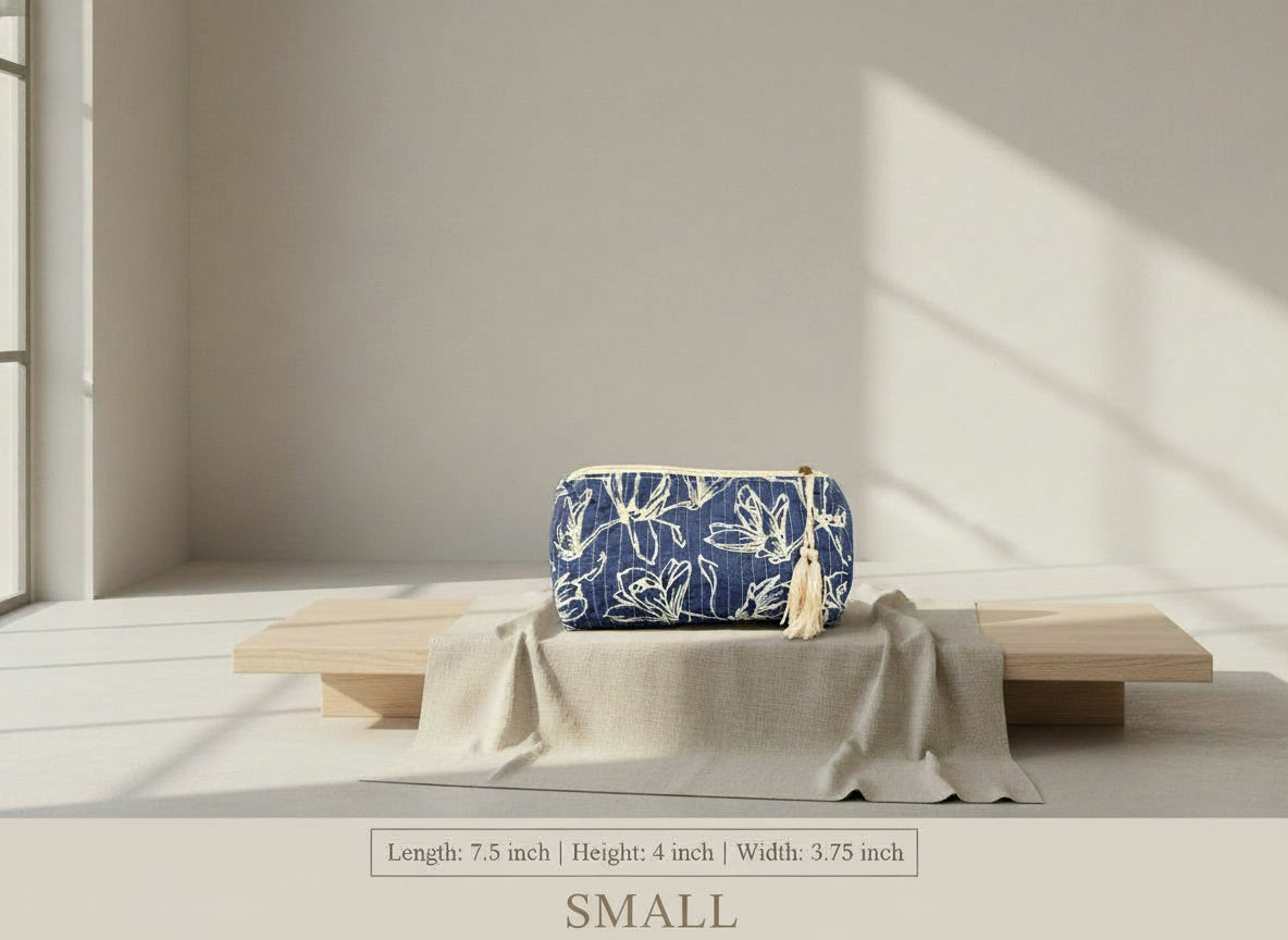 Blue pouch with white floral pattern and tassel on a brown background